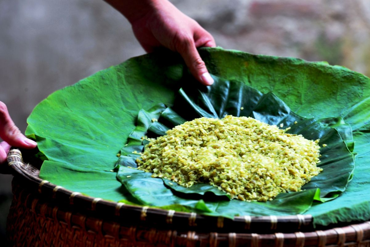 Traditional green rice flakes (Com) wrapped in lotus leaves from Vong village